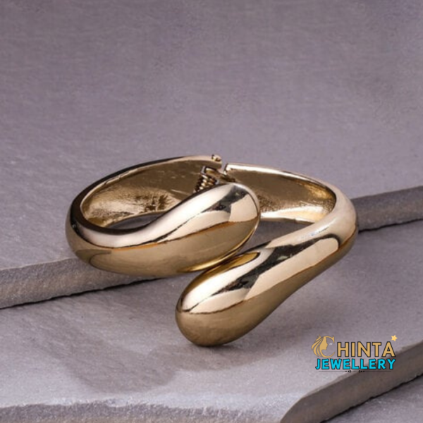 A bold and modern gold cuff bracelet, perfect for adding a statement to your look.