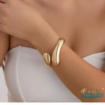 A bold and modern gold cuff bracelet, perfect for adding a statement to your look.
