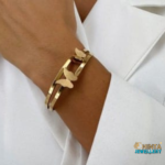 An elegant golden bracelet adorned with delicate butterfly charms, adding a graceful touch to any outfit.