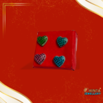 A colorful set of 4 heart-shaped stud earrings with bold polka dot patterns in green, blue, pink, and teal. Perfect for adding a playful vibe to your outfits!