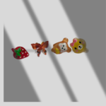 Add a playful touch to your style with this adorable set of 4 cartoon stud earrings, featuring a strawberry, a butterfly, and two charming bears.