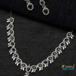 A luxurious emerald and diamond necklace set featuring a regal design, perfect for weddings, parties, and special occasions. Crafted with high-quality gemstones and intricate detailing for a timeless and elegant look.