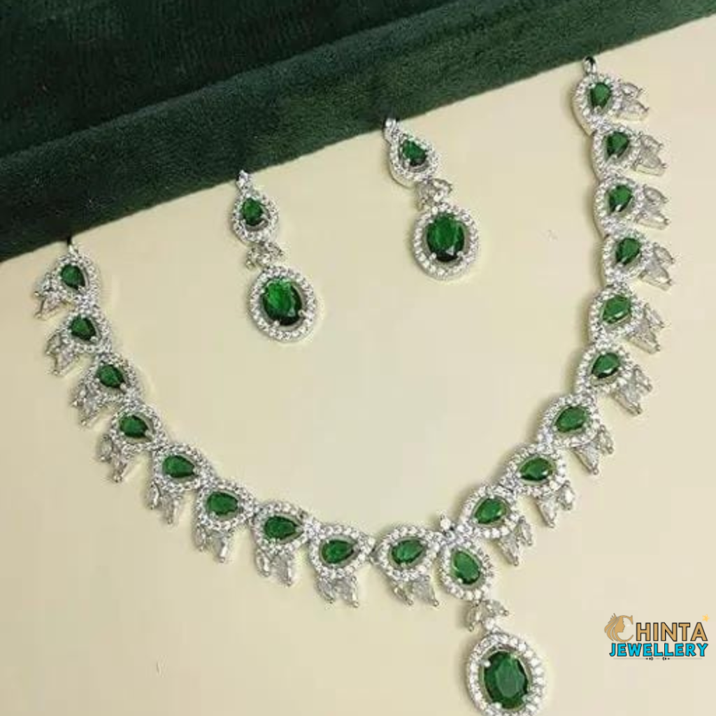 A luxurious emerald and diamond necklace set featuring a regal design, perfect for weddings, parties, and special occasions. Crafted with high-quality gemstones and intricate detailing for a timeless and elegant look.