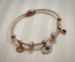 Embrace style and protection with this Evil Eye Charm Bracelet, crafted in a stunning rose gold finish.
