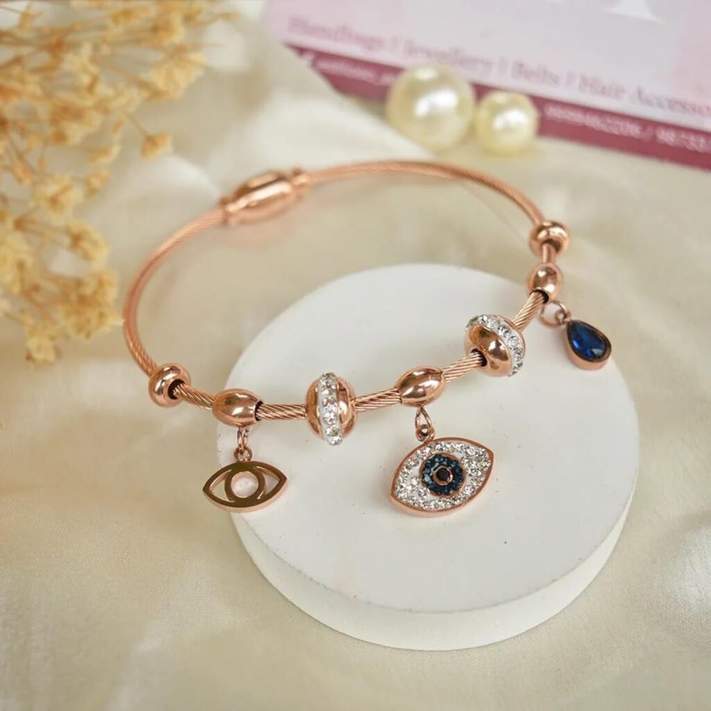 Embrace style and protection with this Evil Eye Charm Bracelet, crafted in a stunning rose gold finish.