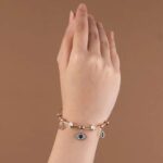 Embrace style and protection with this Evil Eye Charm Bracelet, crafted in a stunning rose gold finish.
